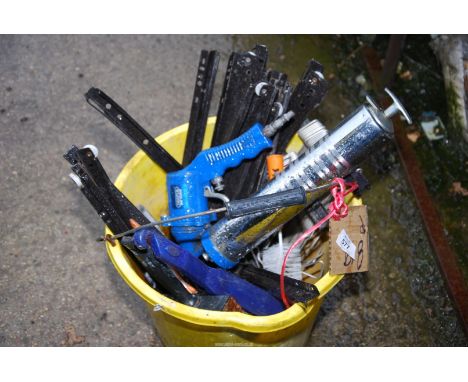 A bucket containing metal roller brackets, brushes, Draper grease gun - air operated.