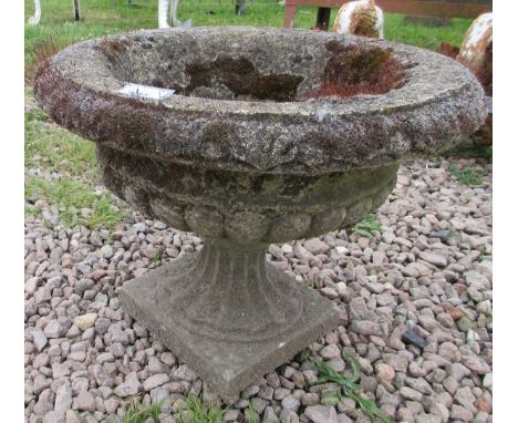 Small stone planter on plinth 