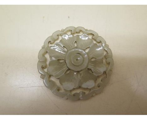 A carved jade roundel, 5.5cm diameter, in good condition 