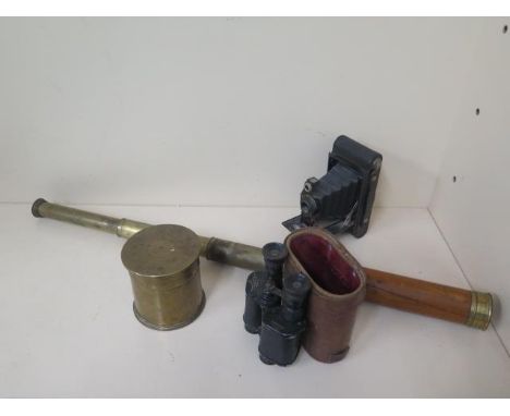 A three pull brass telescope, a pair of standard binoculars, a bellows camera and a trench art shell pot 