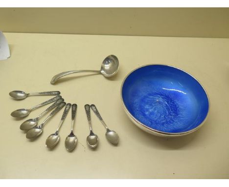 A silver bowl with blue enamel lining, 16.5cm diameter, eight siam silver Neillo coffee spoons and a plated ladle, bowl and s