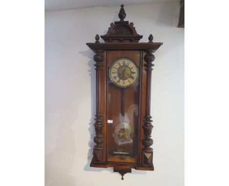 A spring driven wall clock striking on a gong, running and generally good condition, 128cm tall 