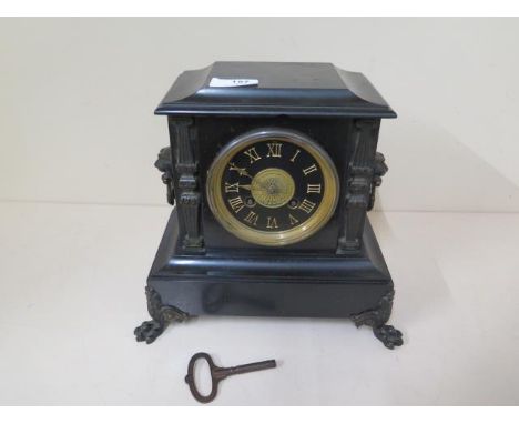 A black slate mantle clock with a French striking movement, 24cm tall x 26cm wide, generally good condition 