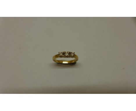 A yellow gold three stone diamond ring, centre stone approx 0.20ct, size Q, not hallmarked, tests to approx 14ct, generally g