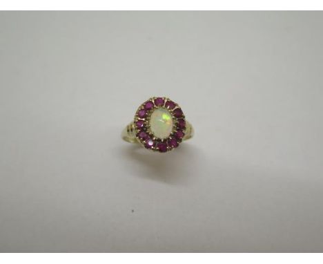 A 9ct yellow gold opal and ruby hallmarked ring, size P, approx 2.8 grams, head approx 12mm x14mm, in good condition 