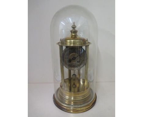 A brass portico clock under a glass dome striking on a bell in running order, some small dents to base but dome good, 45cm ta