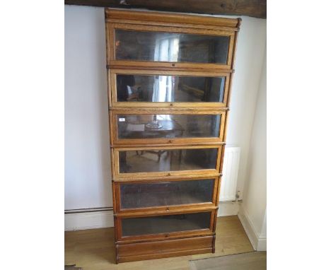 A light oak six section stacking Globe Wernicke bookcase with base and top, 190cm tall x 86.5cm x 30.5cm deep, overall good c