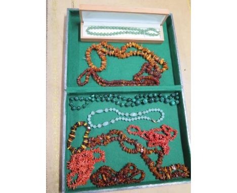 A collection of nine assorted jade, coral and amber and malachite necklaces and a bracelet