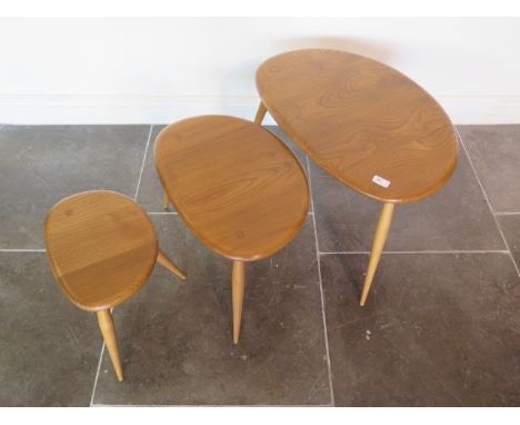 An Ercol light elm nest of pebble tables, some minor marks but good condition, 41cm tall x 65cm x 44cm 