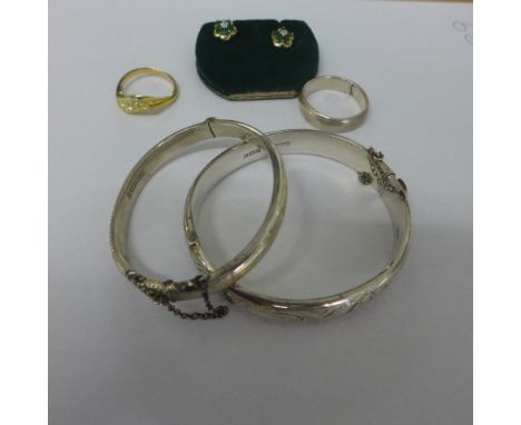 A pair of 10ct emerald earrings, approx 1 gram, a plated dress ring,some plate worn, a silver ring (cut) and two silver bangl