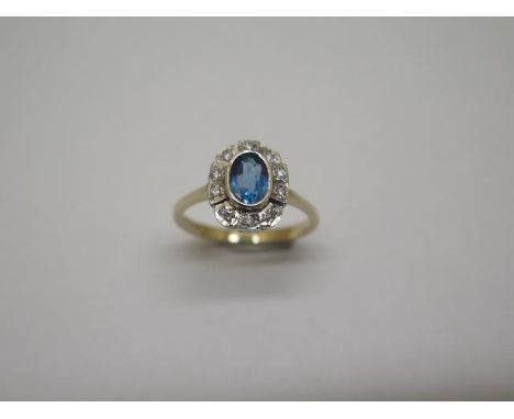 A hallmarked 9ct blue topaz and diamond ring, size N/O, approx 2.7 grams, head approx 11mm x 8mm, in good condition 