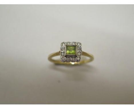 A peridot and diamond 18ct hallmarked ring, size N, approx 2.5 grams, in good condition 