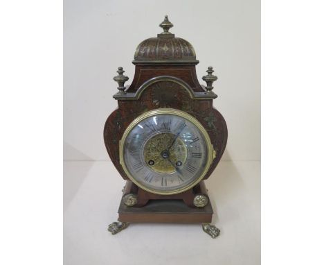 A French mahogany brass inlaid mantle clock striking on a bell, 31cm tall, standing on claw feet in generally good condition,