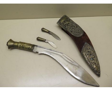 A Kukri with embossed Gurka crossed knives decoration to the scabbard, length 41cm, reasonably good condition, wear and marks