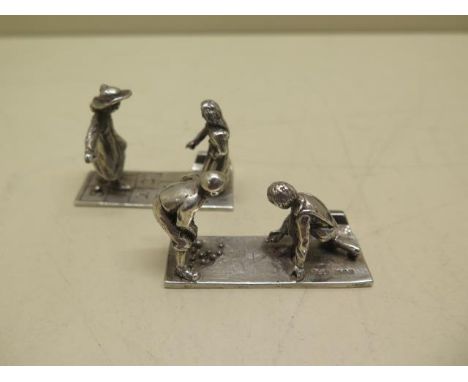 Two silver place holders of children playing, maker TCJ London hallmarks, 4.5cm long, approx 1.8 troy oz, both in good condit