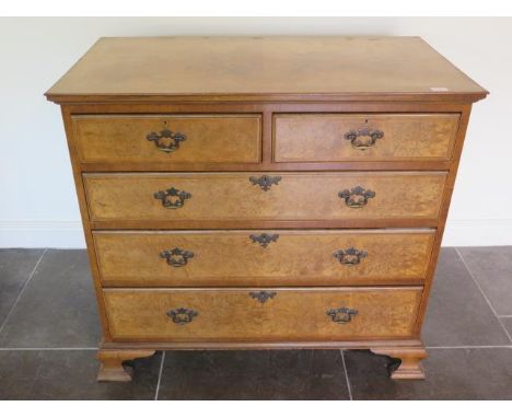 A 19th century walnut veneered five drawer chest with a quarter veneered top on shaped bracket feet, 95cm tall x 103cm x 56cm