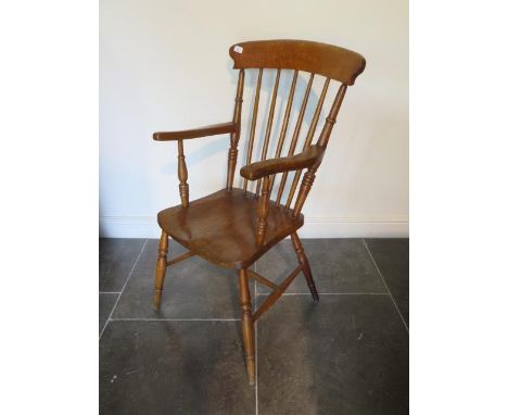 A 19th century ash and elm stick back armchair, 102cm tall x 46cm wide x seat height 44cm, with a light varnished finish 