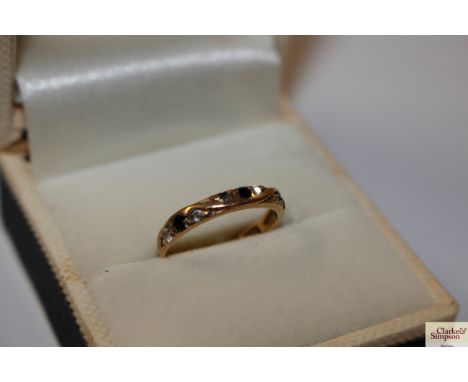 A 9ct gold ring set with white and black stones (one stone missing) weight approx. 1.2g