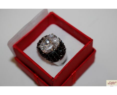 A large silver dress ring set with Diamonique black and white cubic zirconia stones, size Q/R, total weight approximately 10g