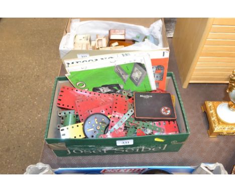 A box containing various vintage Meccano with instruction manuals