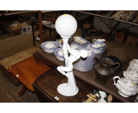 An art deco style lamp base with glass shade