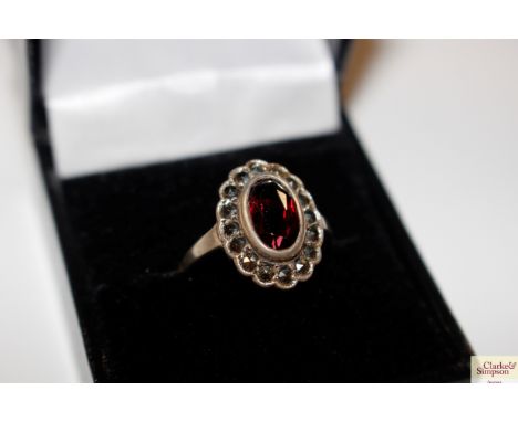 A boxed silver; marcasite and garnet set ring