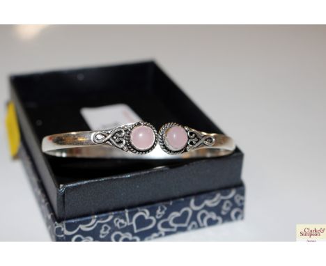 A silver and rose quartz bangle marked .925
