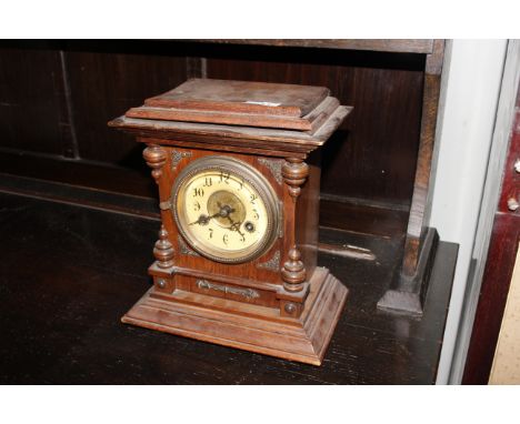 An oak cased two hole mantle clock