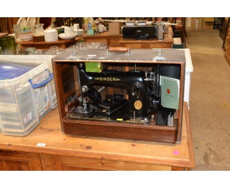 An electric Singer sewing machine in fitted case, Number EF500266, sold as collectors item