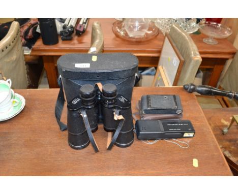 A pair of Pentax binoculars and two vintage cameras