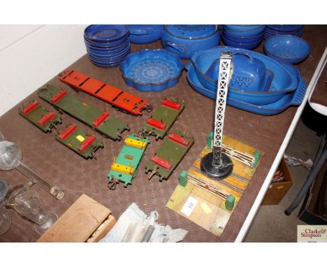 A Hornby "0" gauge level crossing and signal tower and seven vintage Hornby "0" gauge trailers