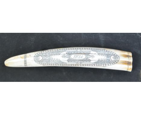 A vintage 20th century resin Scrimshaw horn with ebonised inscriptions carving. One side of the item having an oval shaped de