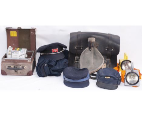 A lot containing a selection of Railway caps, Bardic lamps, Guards Bag and a cased ticket machine complete with a London Tran