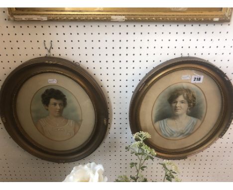 A pair of small oval portrait photos