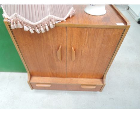 A vintage teak effect record cabinet, on casters 