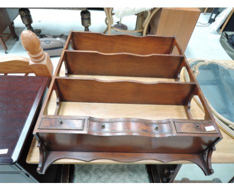 A reproduction mahogany wall shelf