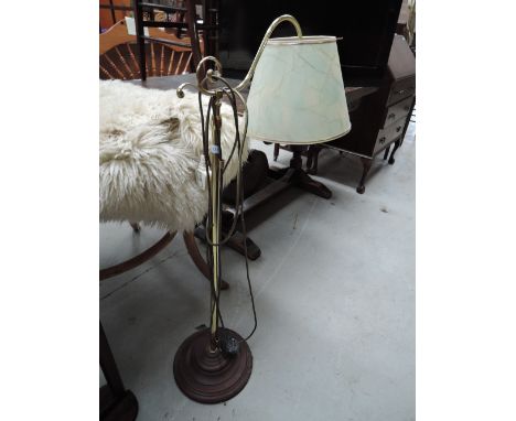 A brass based extendable standard lamp