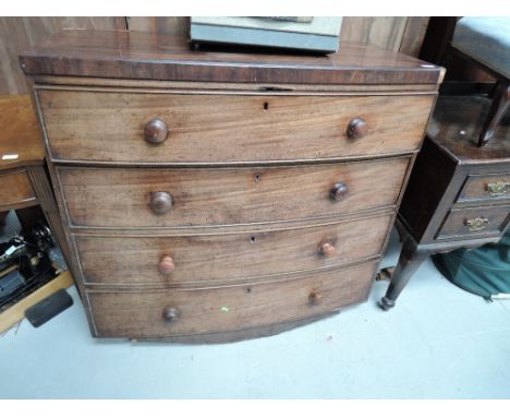 A Victorian mahogany bow front chest of four drawers, some damage to feet