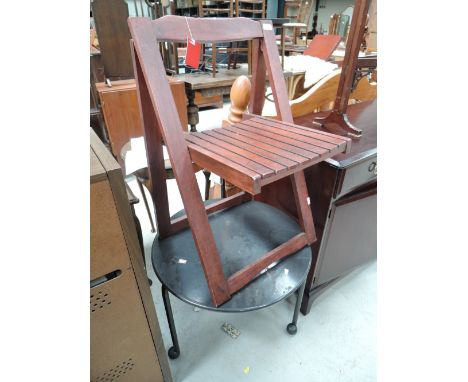 A metal garden table and wooden garden chair