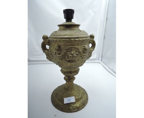 An antique cast urn as lamp with cherub and twin handle design