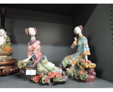 A pair of ceramic Chinese figures of Geisha or similar bearing impressed stamp to base