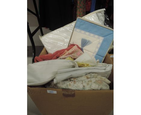 A collection of vintage and retro bedding, pillow cases and net curtains.