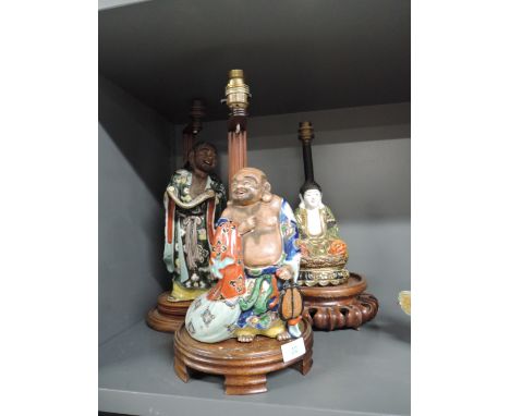 A selection of Chinese export lamp base figures possibly early 20th century Buddhist deity and similar monks