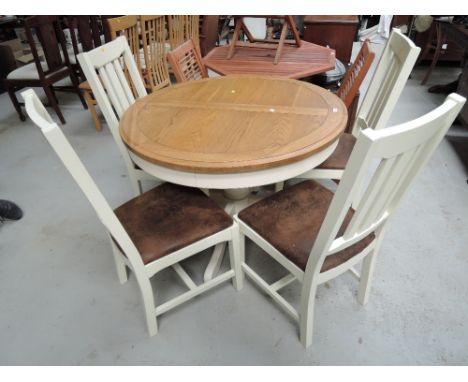 A modern oak and cream extendable dining table and chair set