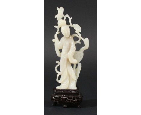 CHINESE SPECKLED WHITE JADE MING STYLE FIGURE OF GUANYIN, carved standing holding branches with a crane to her side, with sta