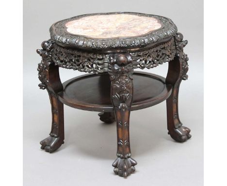 CHINESE HARDWOOD AND PINK MARBLE INSET STAND, the lobed top with scrolling foliate decoration above a pierced apron, shelf st