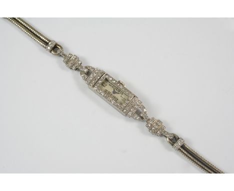 AN ART DECO LADY'S DIAMOND WRISTWATCH the rectangular-shaped dial with Arabic numerals, with single-cut diamonds set to the b