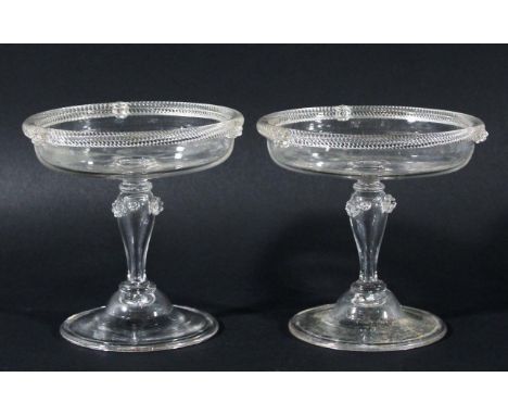 PAIR OF GLASS PATCH STANDS, possibly 18th century, the shallow bowl with rope twist rim, hollow baluster stem with applied fl