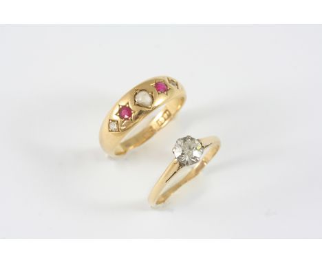 A DIAMOND SOLITAIRE RING the circular-cut diamond is set in 18ct. gold, size K, together with an 18ct. gold gypsy ring set wi