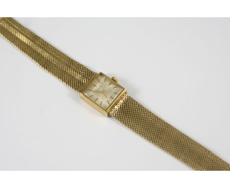 A LADY'S 9CT. GOLD WRISTWATCH BY BUREN the signed square-shaped dial with baton numerals, on an integrated gold mesh bracelet